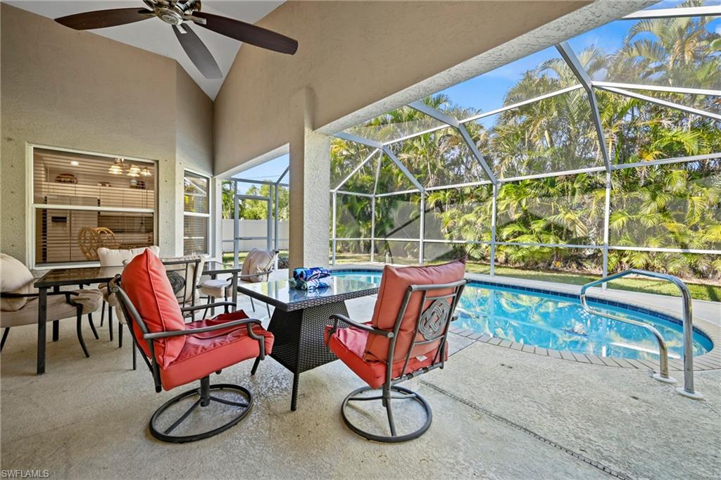 Swimming pool featuring a sunroom, a patio area, a lanai, and outdoor dining space