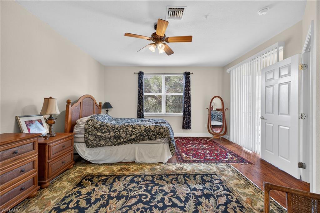 Bedroom with ceiling fan and wood finished floors