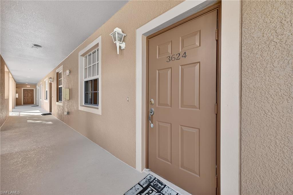 Entrance to property with stucco siding