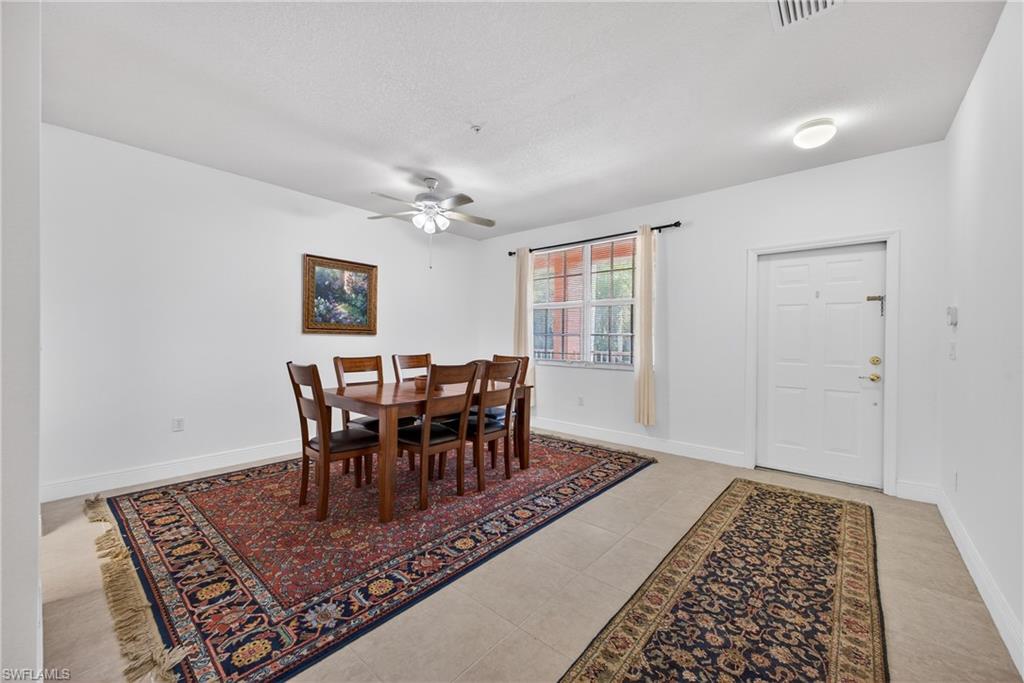 Dining area featuring ceiling fan and light tile patterned floors