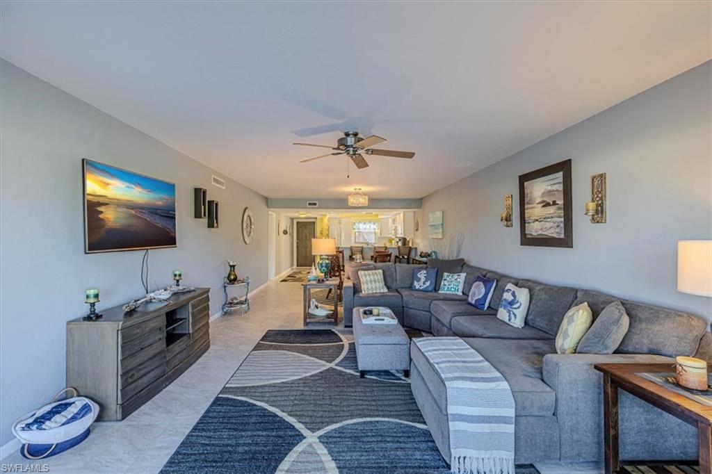 Living room with ceiling fan and baseboards