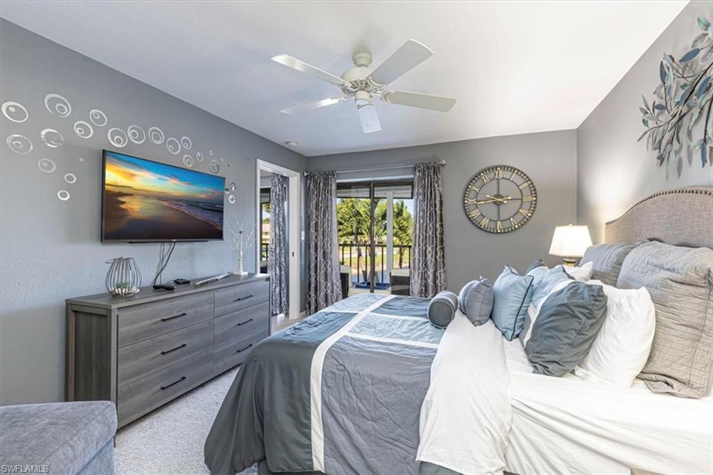 Bedroom featuring access to outside, carpet, and ceiling fan