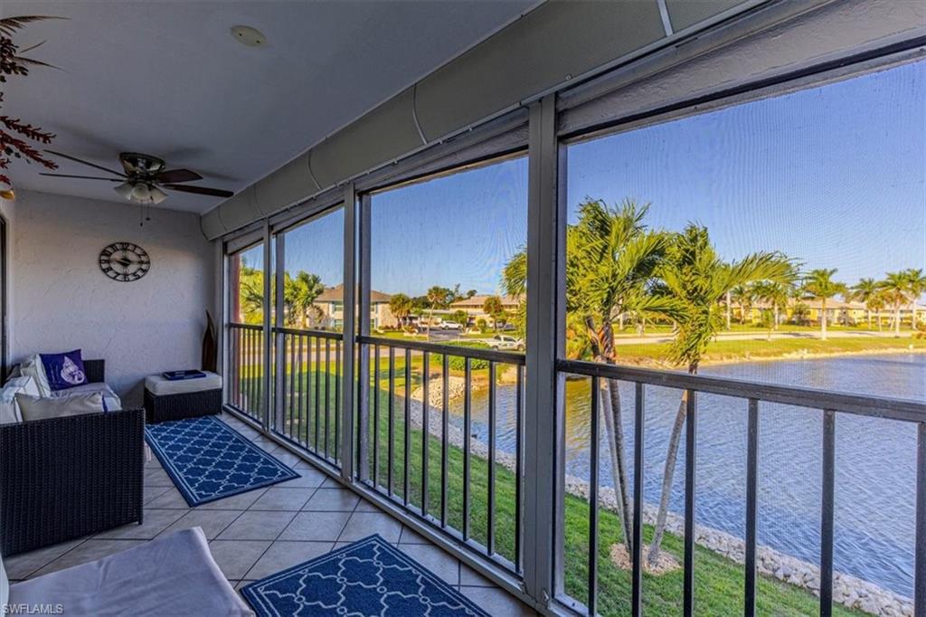 Sunroom featuring a water view