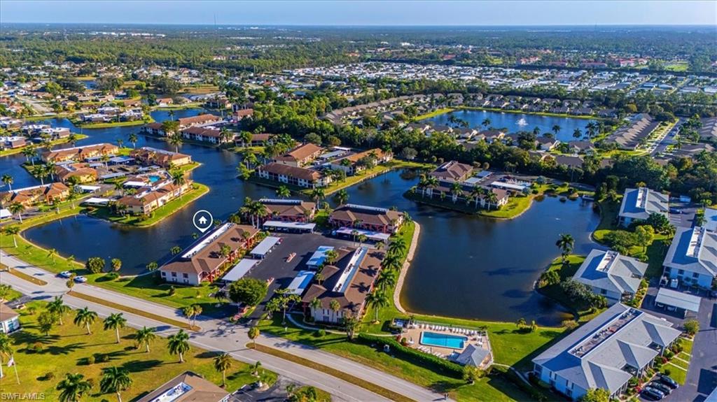Aerial overview of property's location featuring a nearby body of water and nearby suburban area