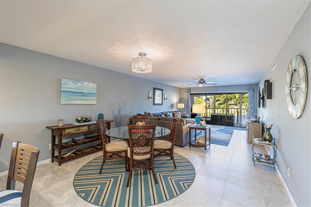 Dining room with light tile patterned floors and a ceiling fan