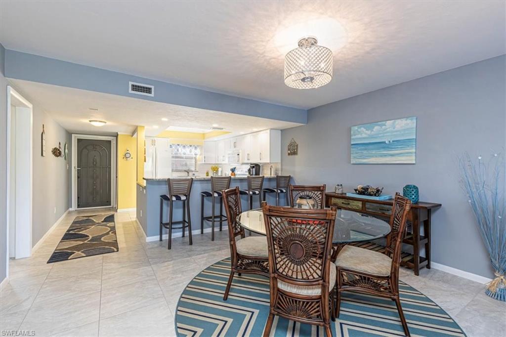 Dining room featuring recessed lighting and light tile patterned floors