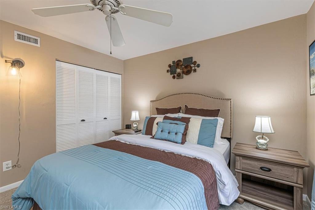 Bedroom with carpet, a closet, and a ceiling fan