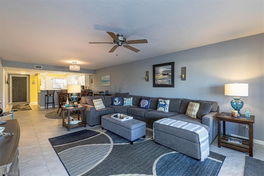 Living area featuring baseboards and a ceiling fan