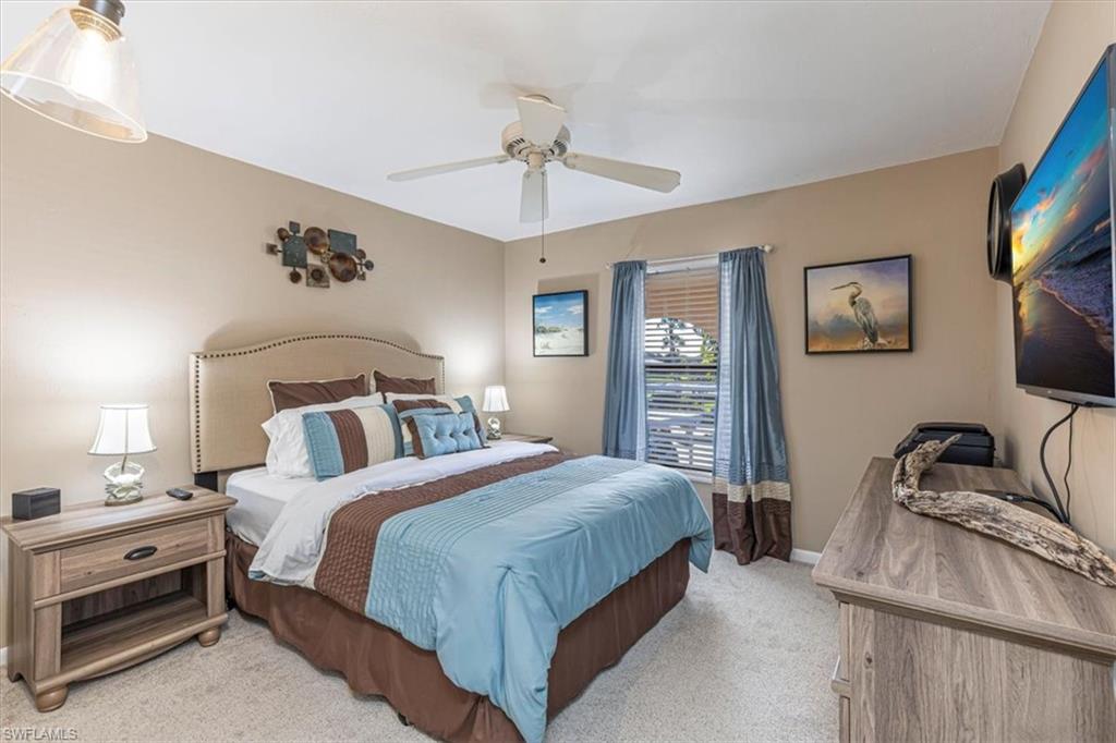 Bedroom with light colored carpet and ceiling fan
