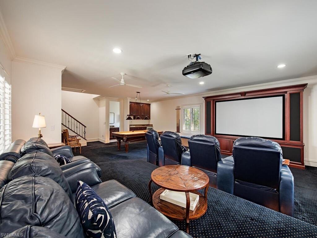Home theater featuring billiards table, ornamental molding, recessed lighting, carpet floors, and ceiling fan