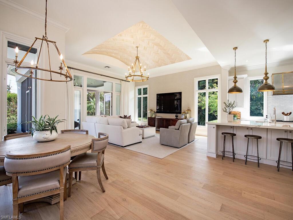 Dining space featuring a chandelier, light wood-type flooring, and crown molding