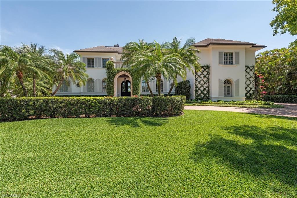 Mediterranean / spanish house featuring stucco siding and a front yard