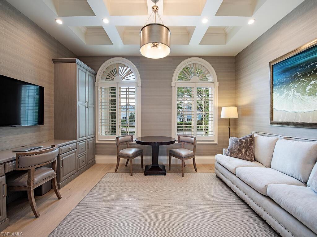 Living area featuring wallpapered walls, light wood-type flooring, coffered ceiling, beam ceiling, and recessed lighting
