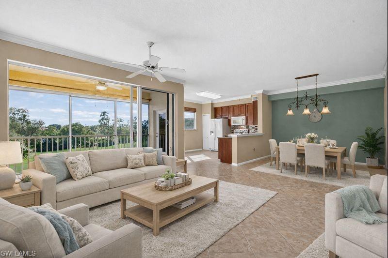 Living room with plenty of natural light, crown molding, and light tile patterned flooring
