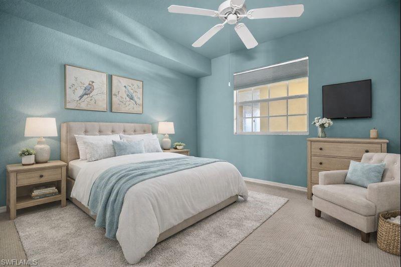 Bedroom featuring ceiling fan and carpet