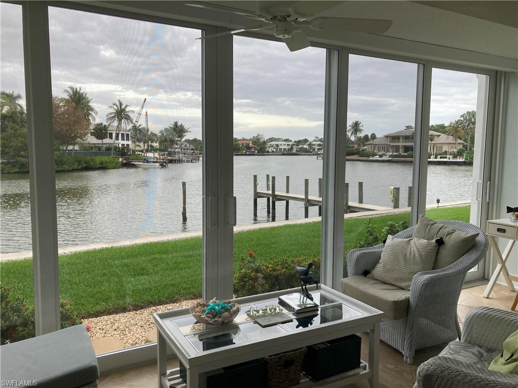 Sunroom / solarium featuring a water view