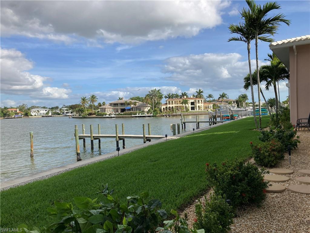 Dock with a lawn, a water view, and a residential view