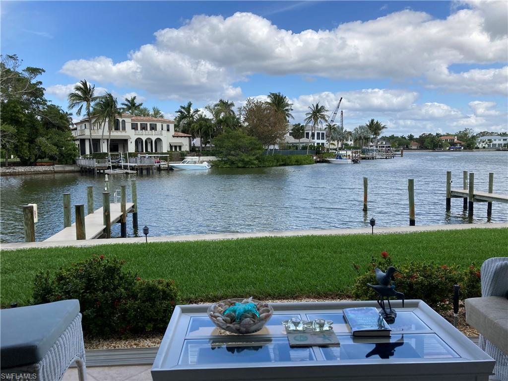 Dock area featuring a water view and a yard