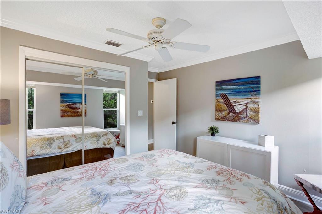 Bedroom featuring ornamental molding, ceiling fan, and a closet