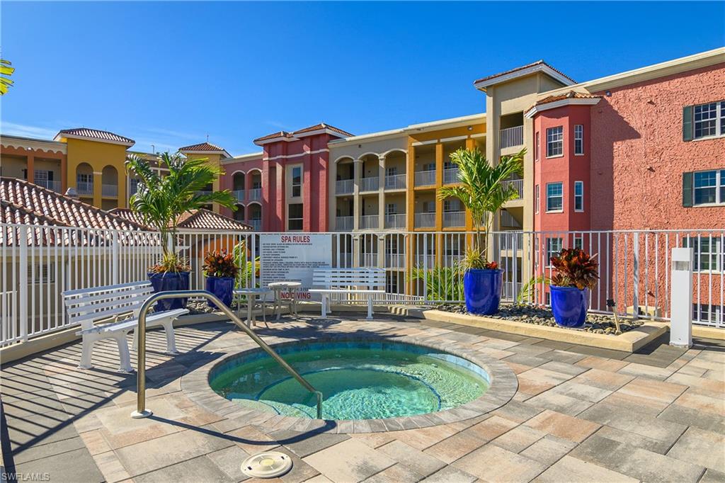 View of pool with a swimming pool, a patio area, and a hot tub
