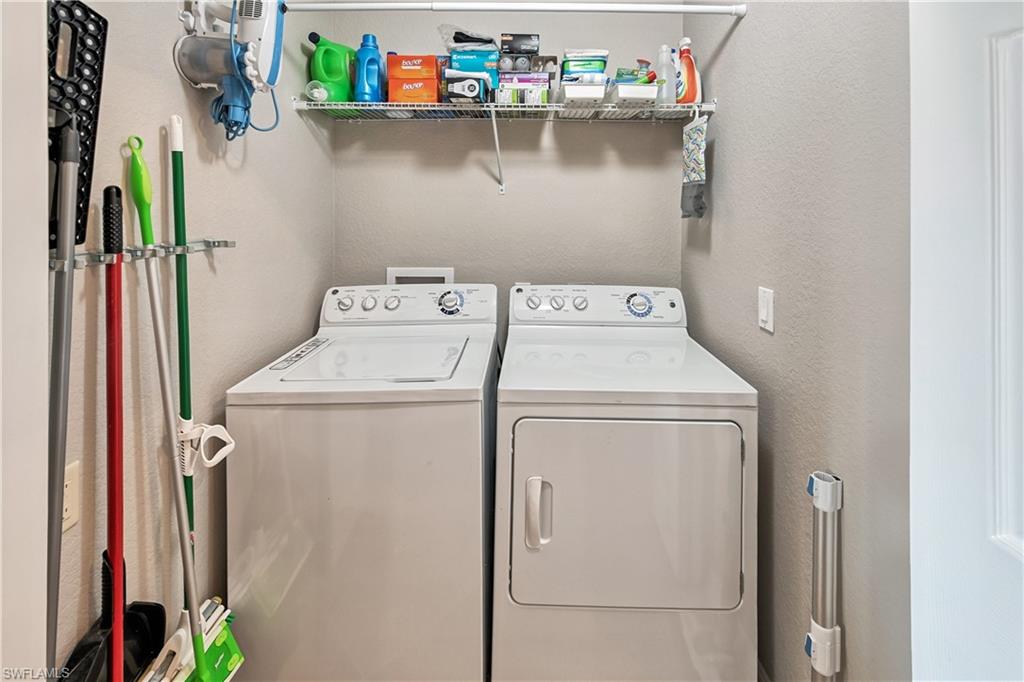 Washroom with washer and clothes dryer