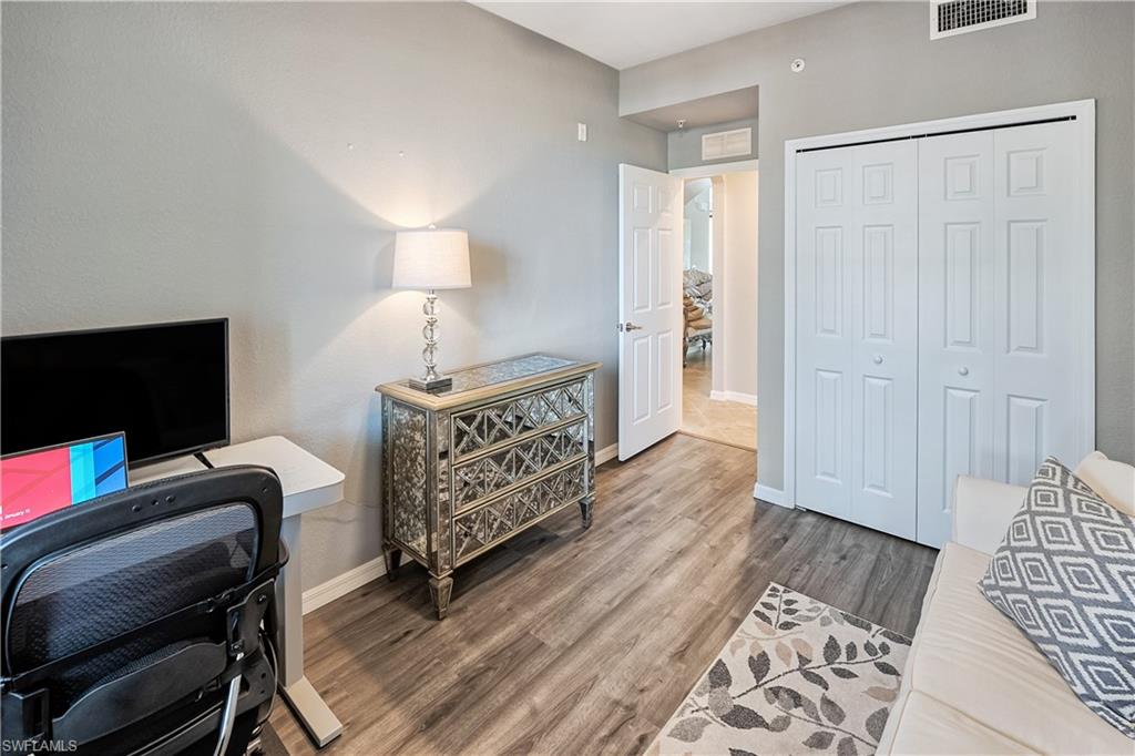 Home office with wood-type flooring