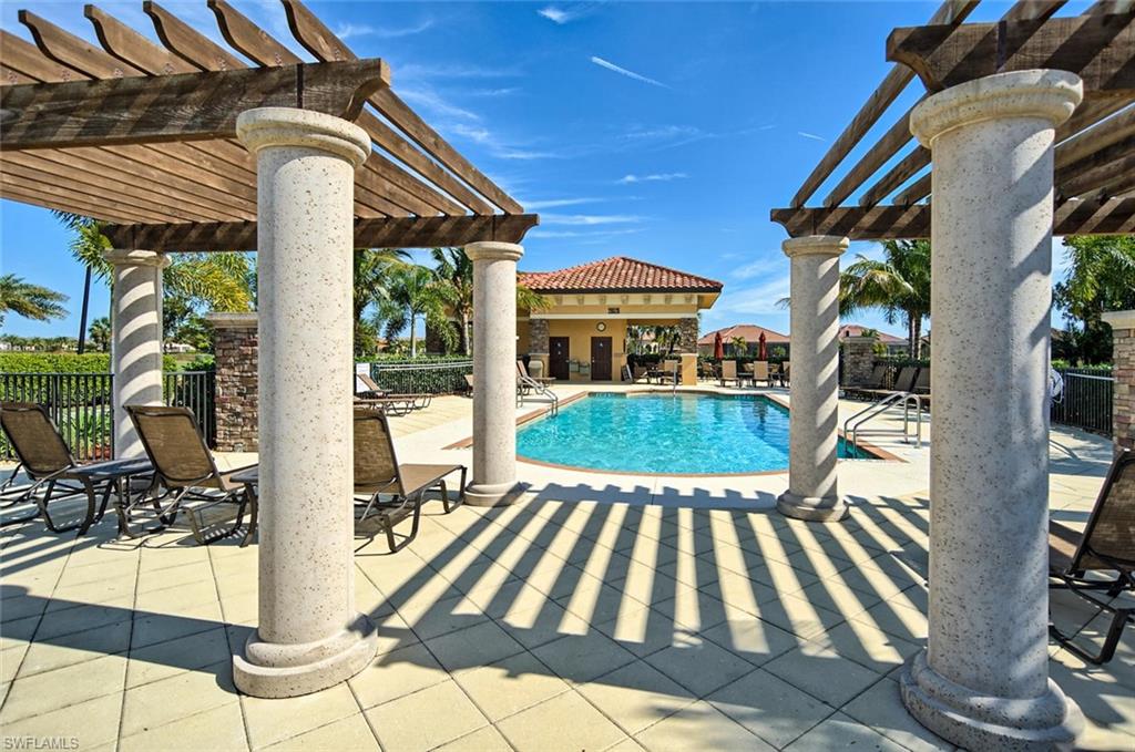 Community pool featuring a pergola and a patio area