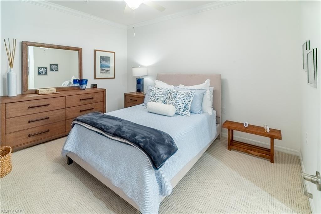 Bedroom featuring ornamental molding, carpet floors, and a ceiling fan