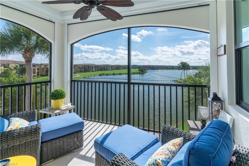 Sunroom / solarium featuring a balcony, a water view, an outdoor living space, and ceiling fan
