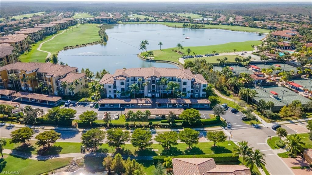 Drone / aerial view of a nearby body of water and a golf club