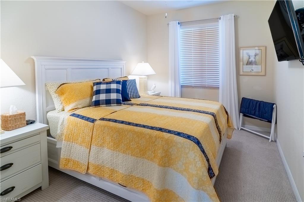 Bedroom featuring light colored carpet
