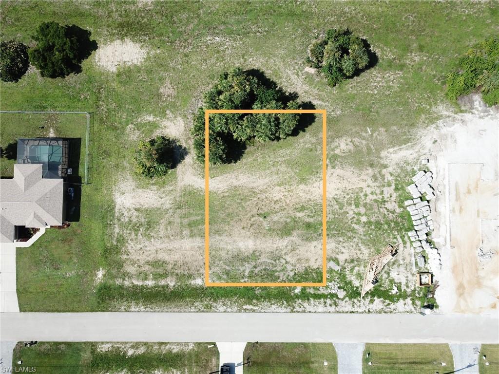Aerial view of property and surrounding area featuring property parcel outlined