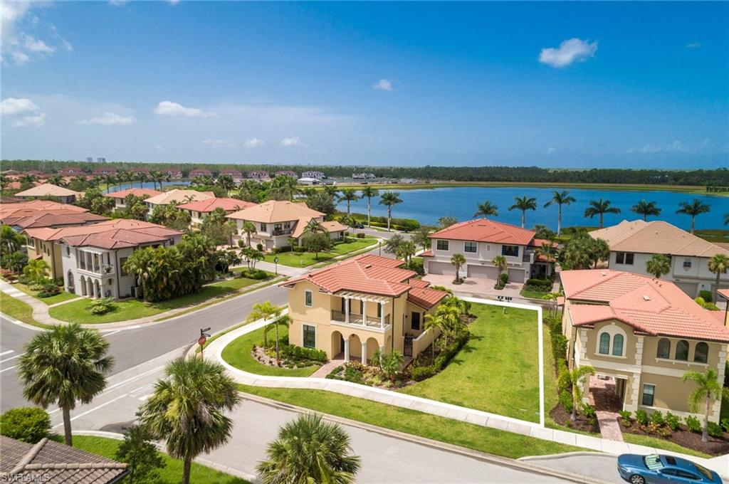 Aerial perspective of suburban area featuring a large body of water