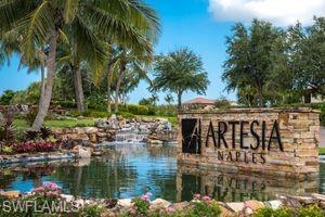 Community / neighborhood sign with a water view