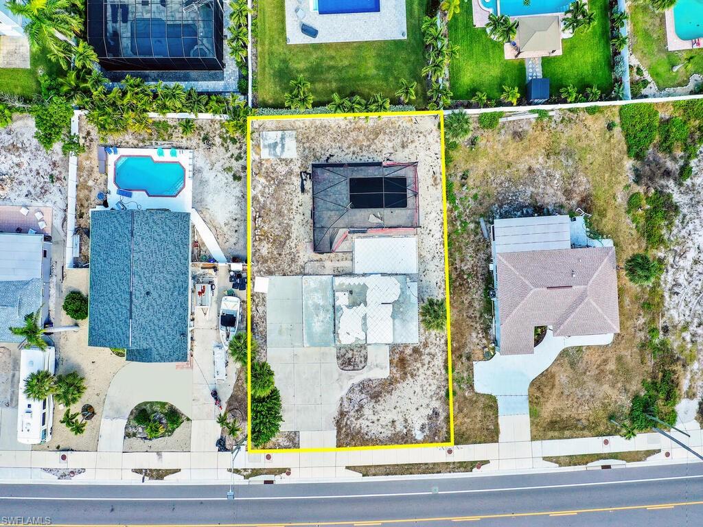 Aerial view of property's location featuring a pool and property parcel outlined