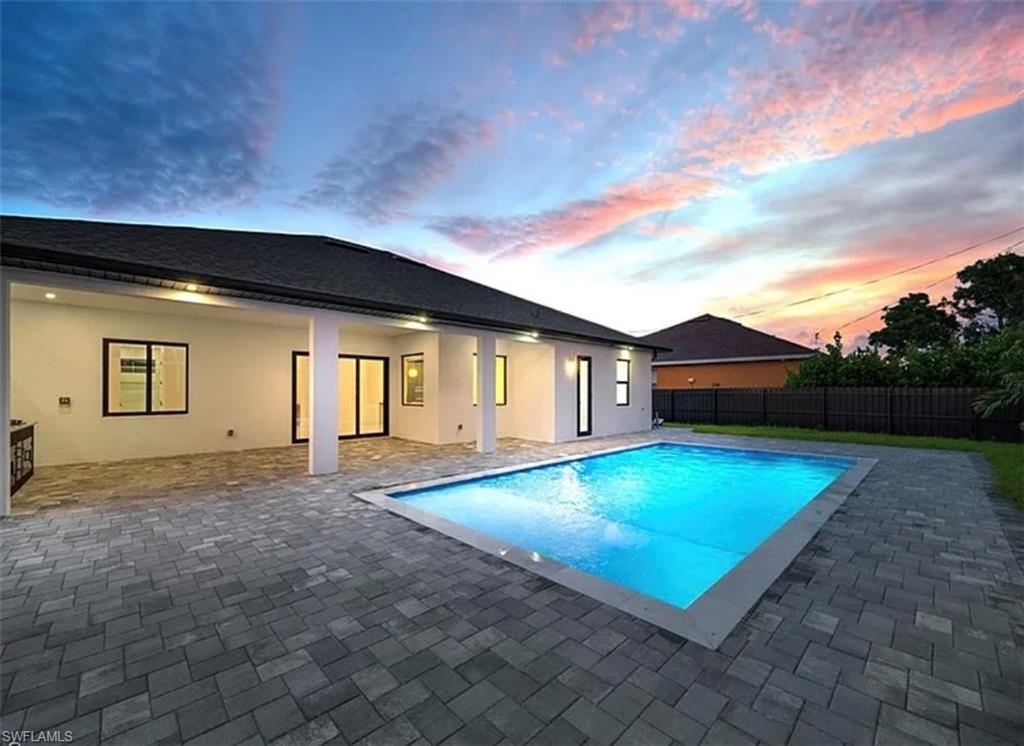 View of pool with a patio and a fenced backyard
