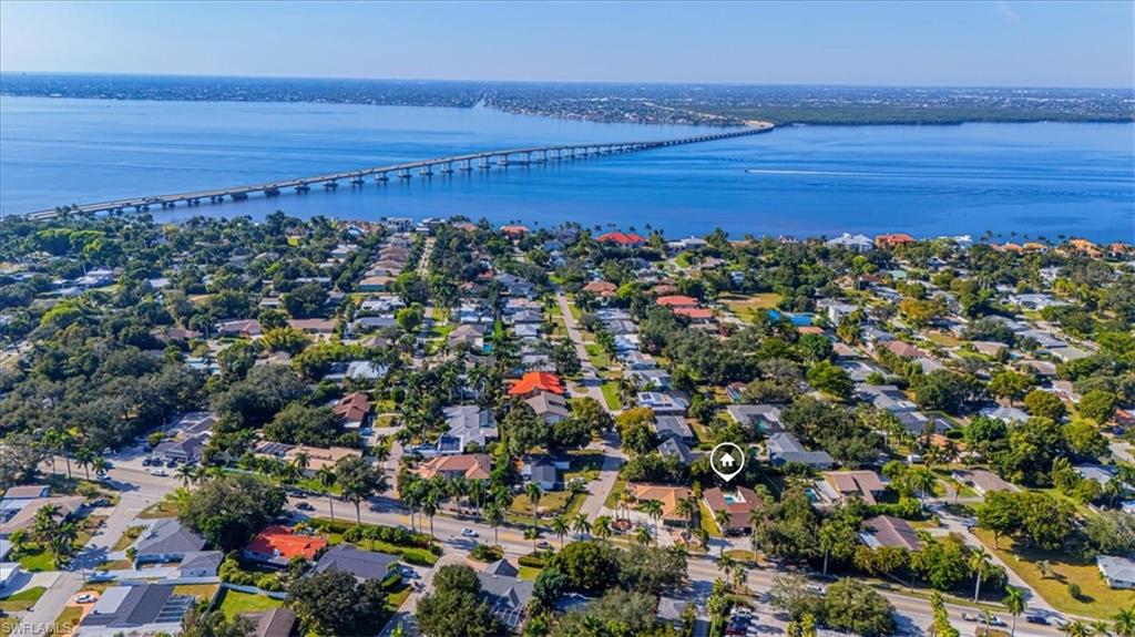 Aerial view of residential area with a notable bridge and a nearby body of water