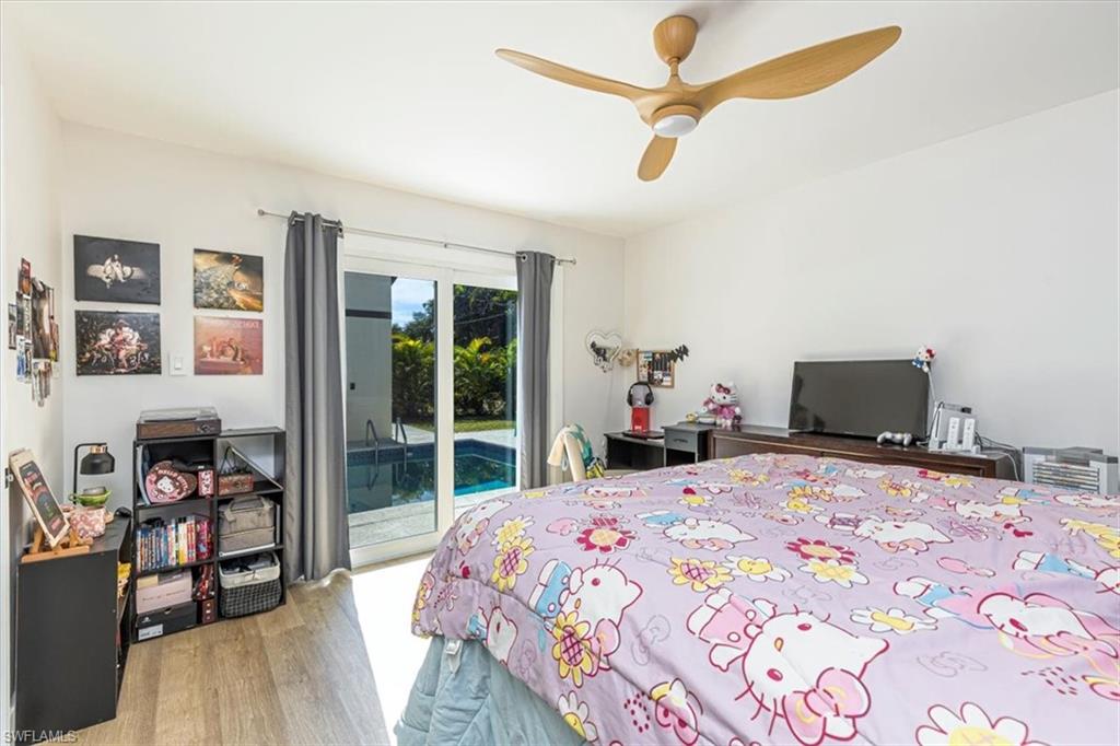Bedroom featuring access to outside, light wood-type flooring, and ceiling fan