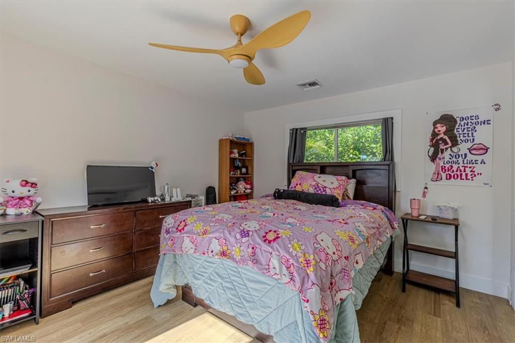 Bedroom with light wood-style flooring and a ceiling fan