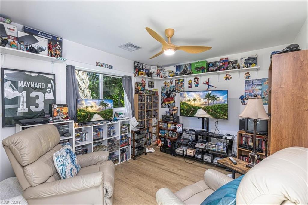 Living room with ceiling fan and wood finished floors