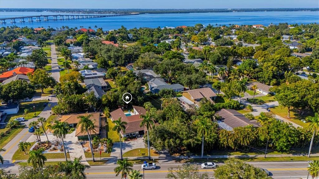 Aerial view of residential area featuring a notable bridge and a large body of water