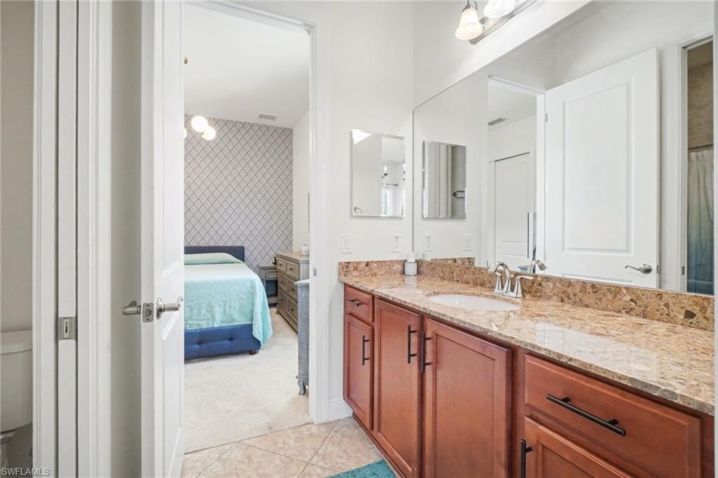 Bathroom with vanity, ensuite bath, light carpet, a shower with shower curtain, and an accent wall