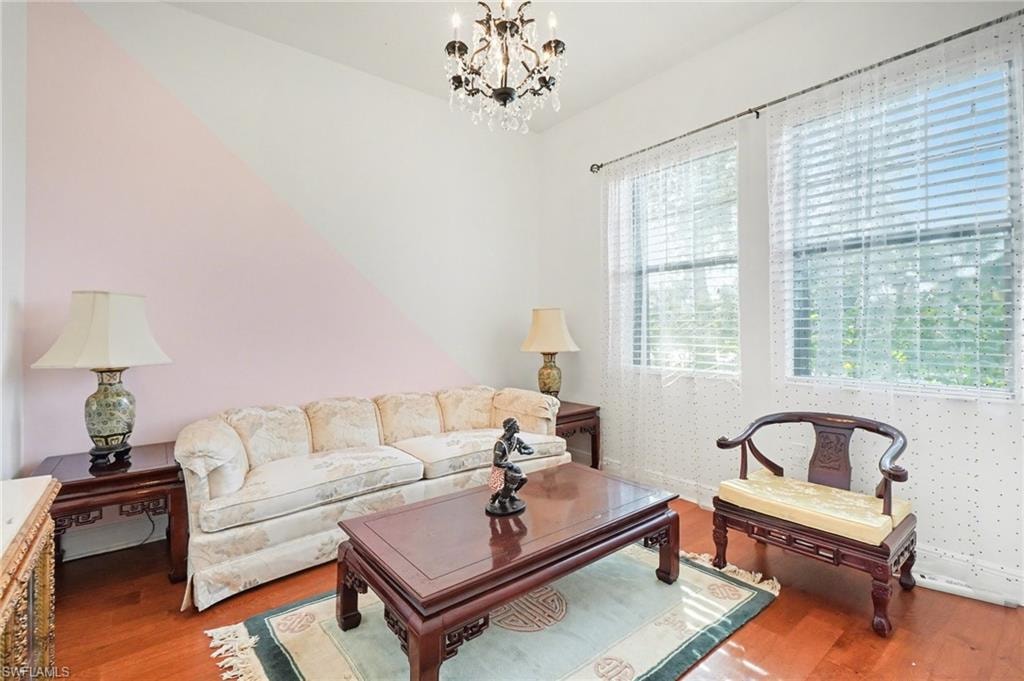 Living room with wood finished floors and a chandelier