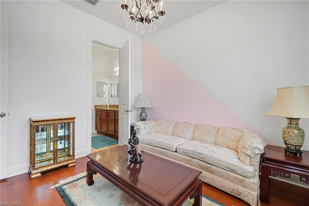 Living room featuring wood finished floors and a chandelier