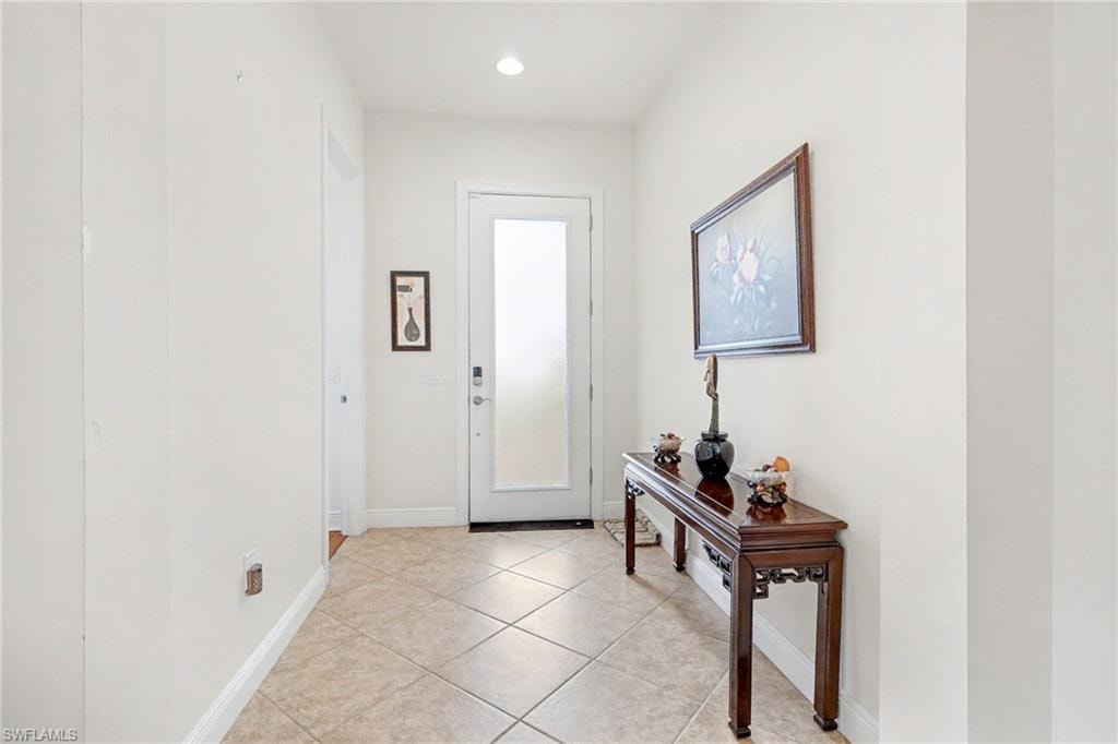Foyer featuring light tile patterned flooring and recessed lighting