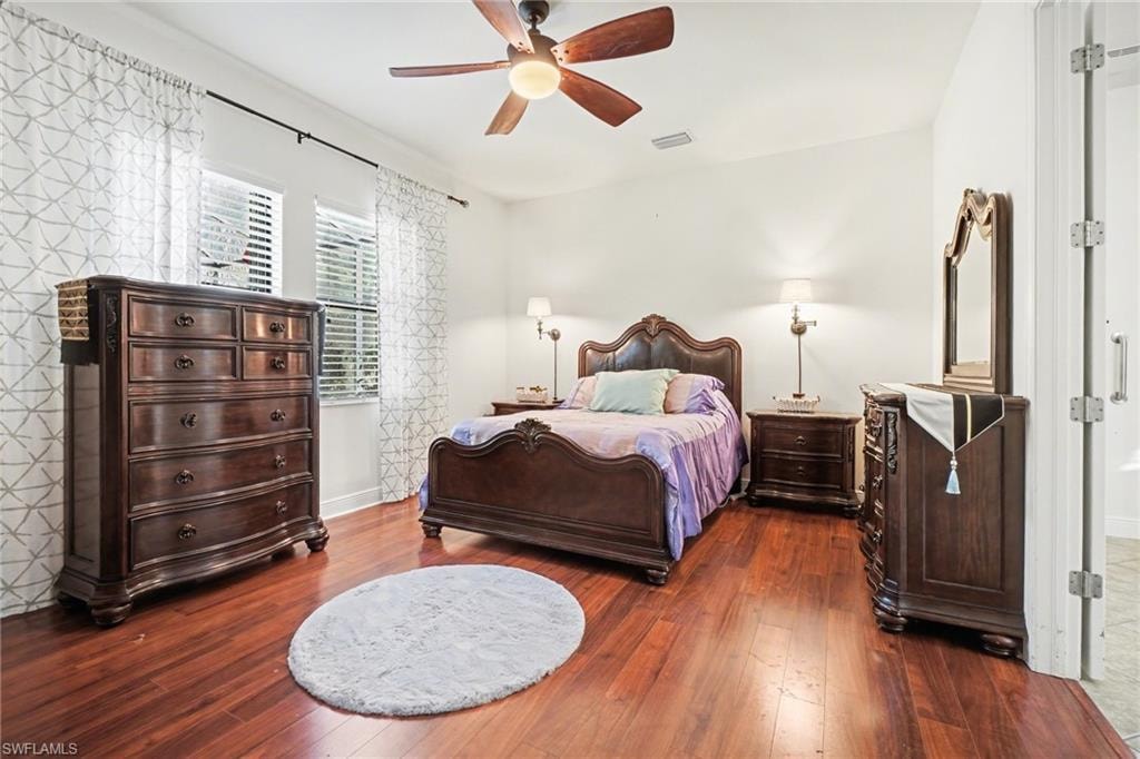 Bedroom featuring ceiling fan and dark wood finished floors