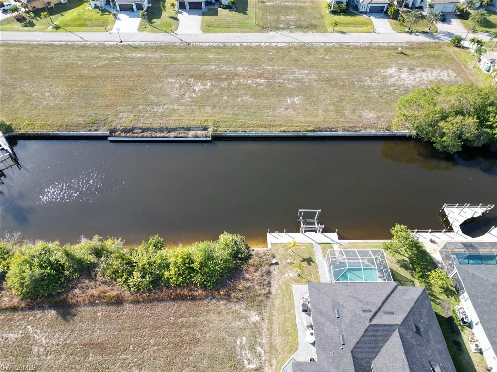 Aerial view of residential area featuring a large body of water