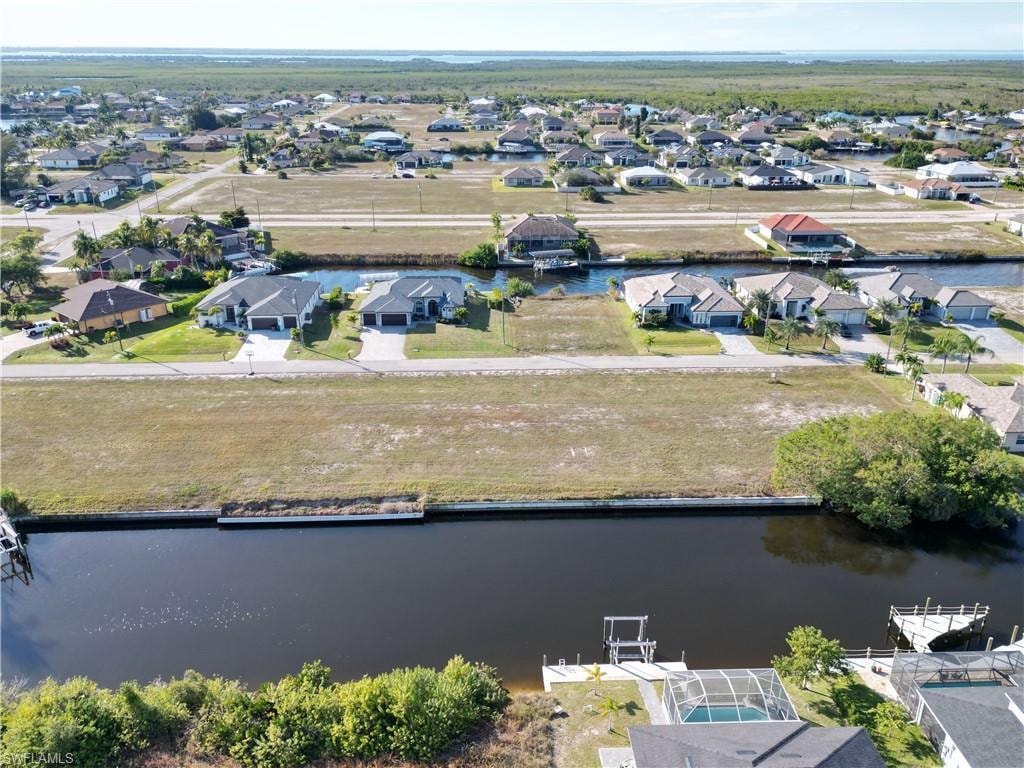 Aerial view of residential area featuring a large body of water