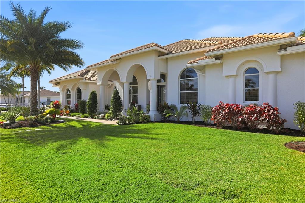 View of property exterior featuring a yard, stucco siding, and a tiled roof