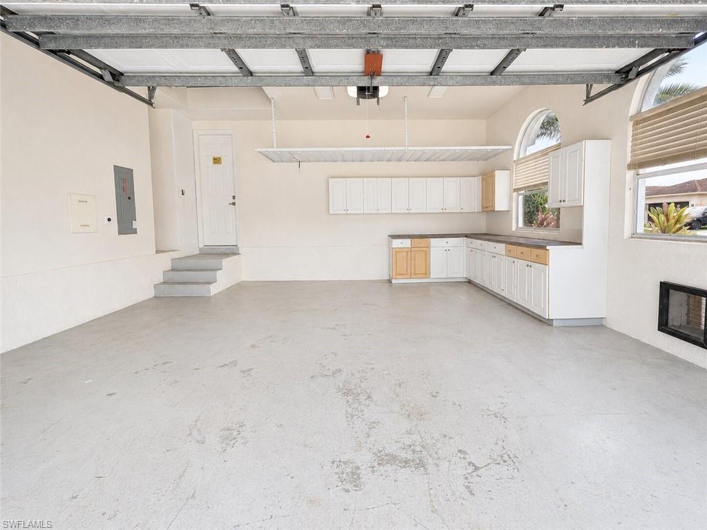 Spacious garage featuring concrete flooring and a fully functional garage door opener